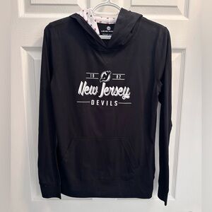 NJ Devils long sleeve T-shirt. Never worn. No tags SLIM FIT. Size Med. Women’s